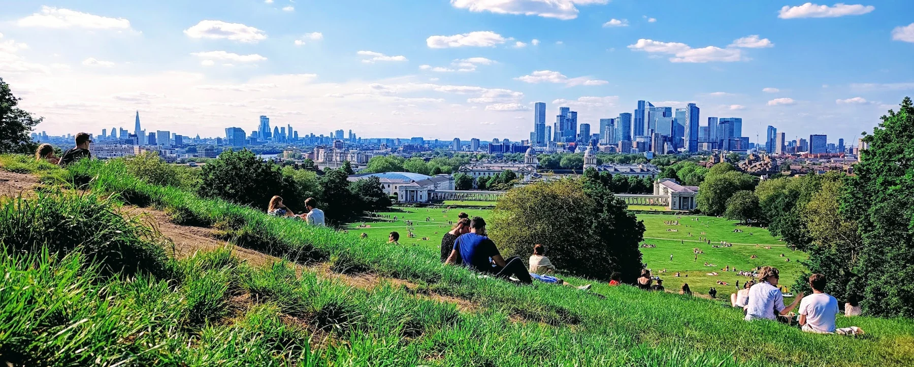 The City of London skyline seen across parkland from a distance